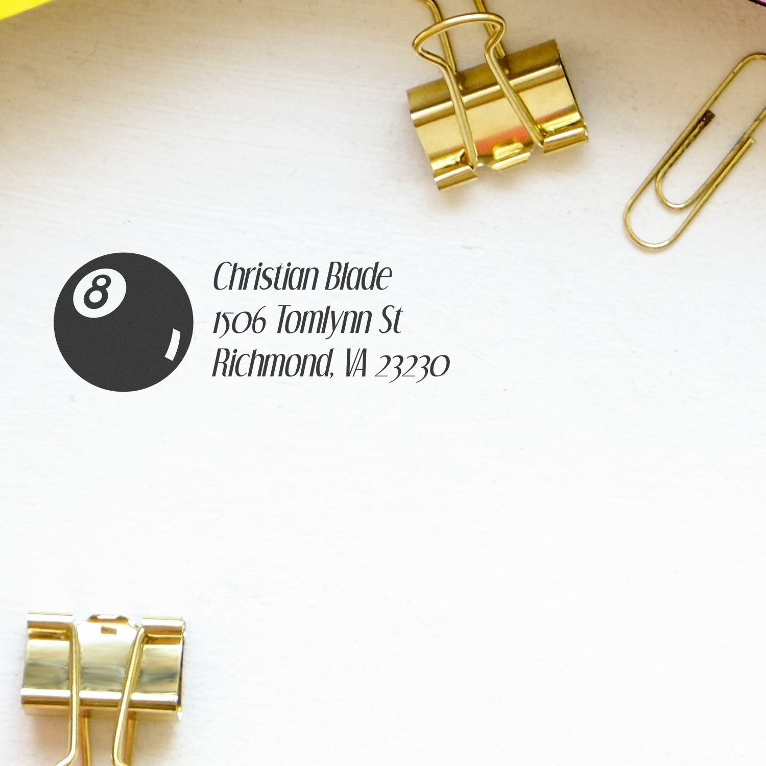 Custom address rubber stamp proof on white paper, styled with gold binder clips for business stationery branding.