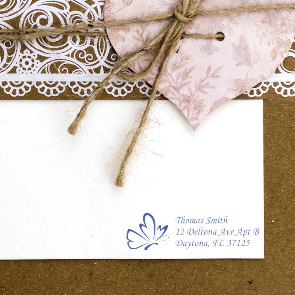 Personalized butterfly address rubber stamp on envelope, shown with handmade lace and twine packaging
