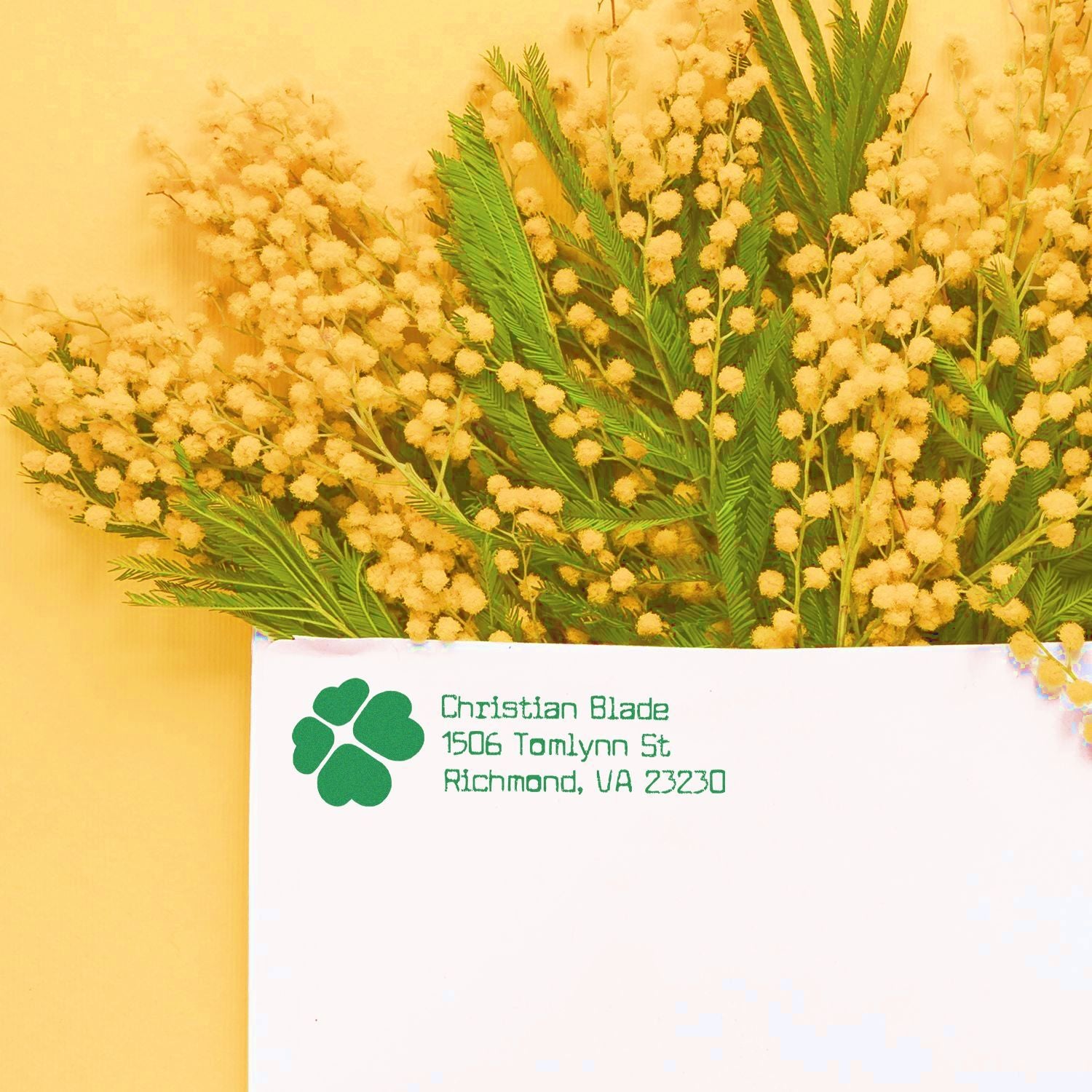 Custom rubber stamp return address on envelope, featuring green logo and Christian Blades Richmond, VA address with floral backdrop.