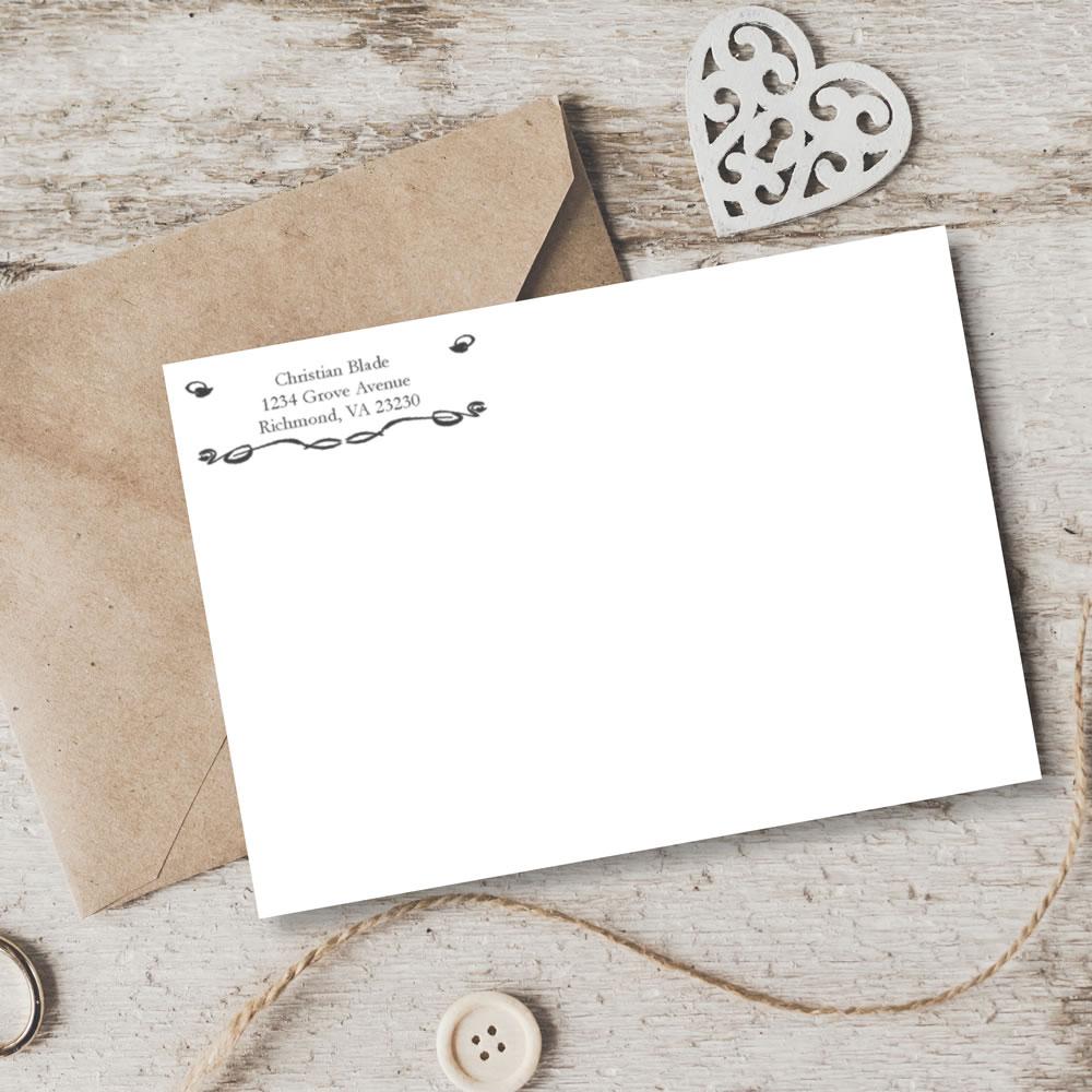 Custom return address rubber stamp on envelope for wedding invitations and personalized stationery.