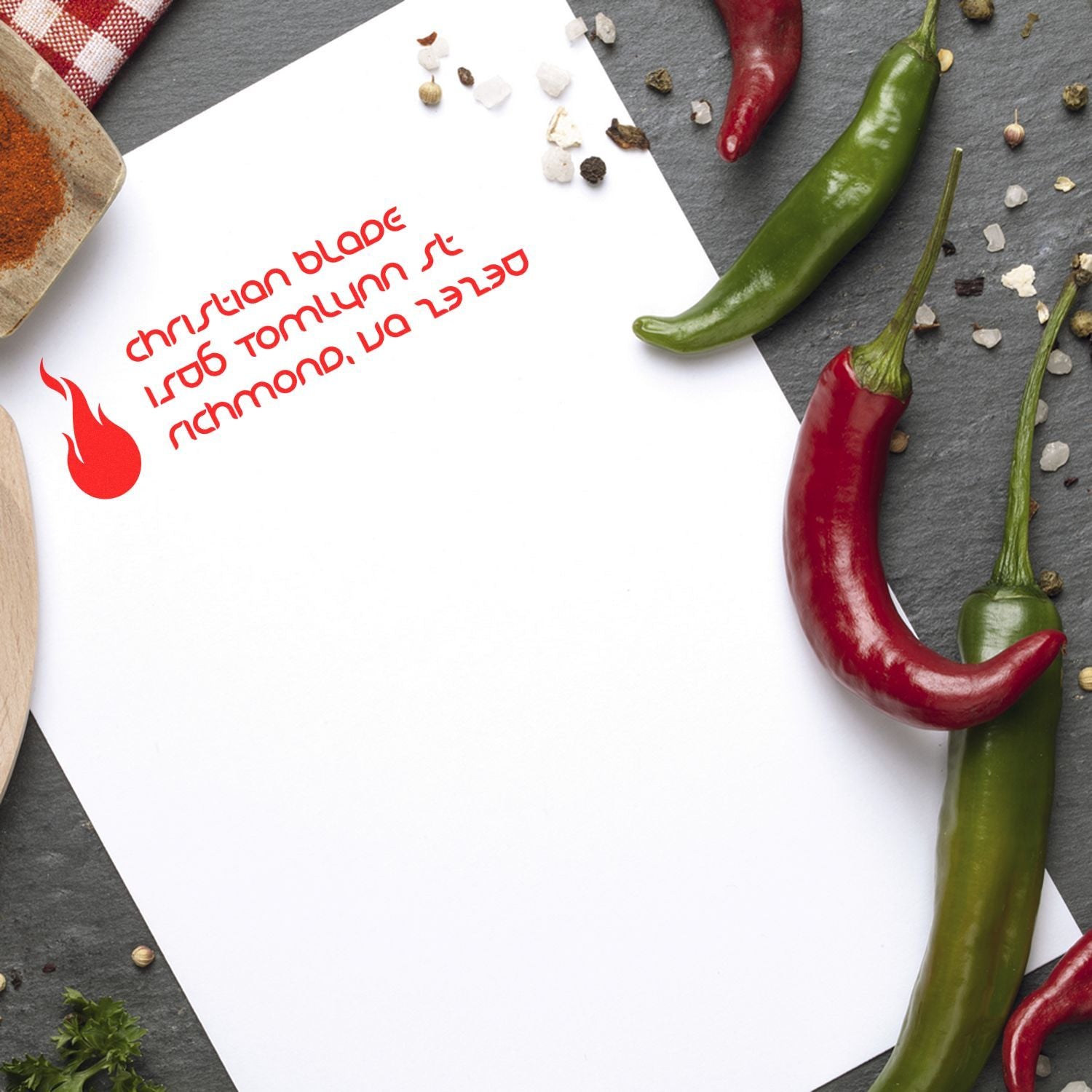 Custom rubber stamp impression with red chili pepper logo on paper, ideal for spicy food branding and packaging.