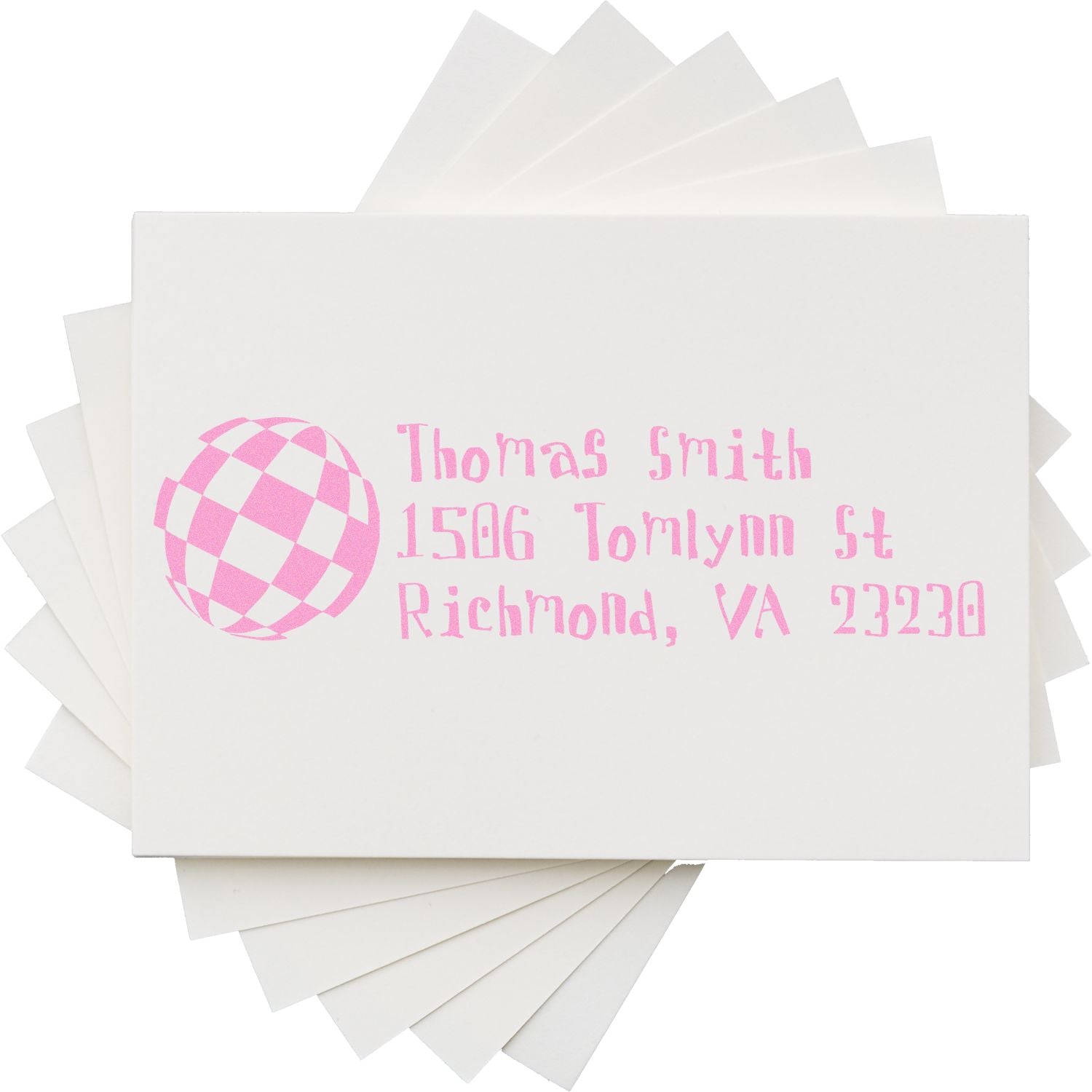 Personalized pink address rubber stamp on envelopes with name, street address, city, and logo for custom mailing.