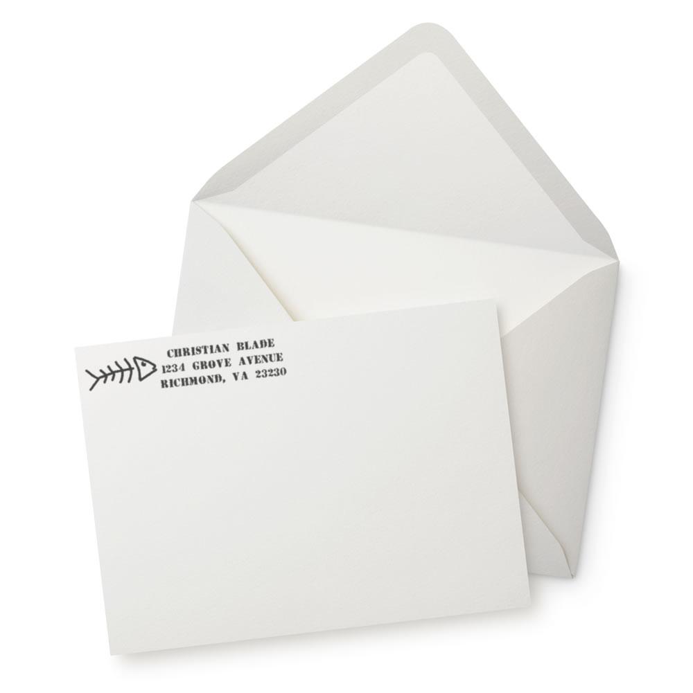 Personalized return address rubber stamp on envelope with fishbone icon and custom name and address imprint