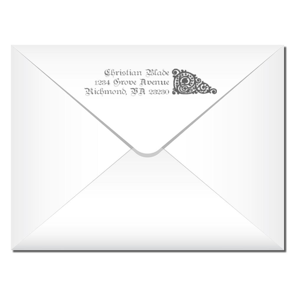Custom return address rubber stamp on white envelope flap with personalized name, address and decorative monogram.
