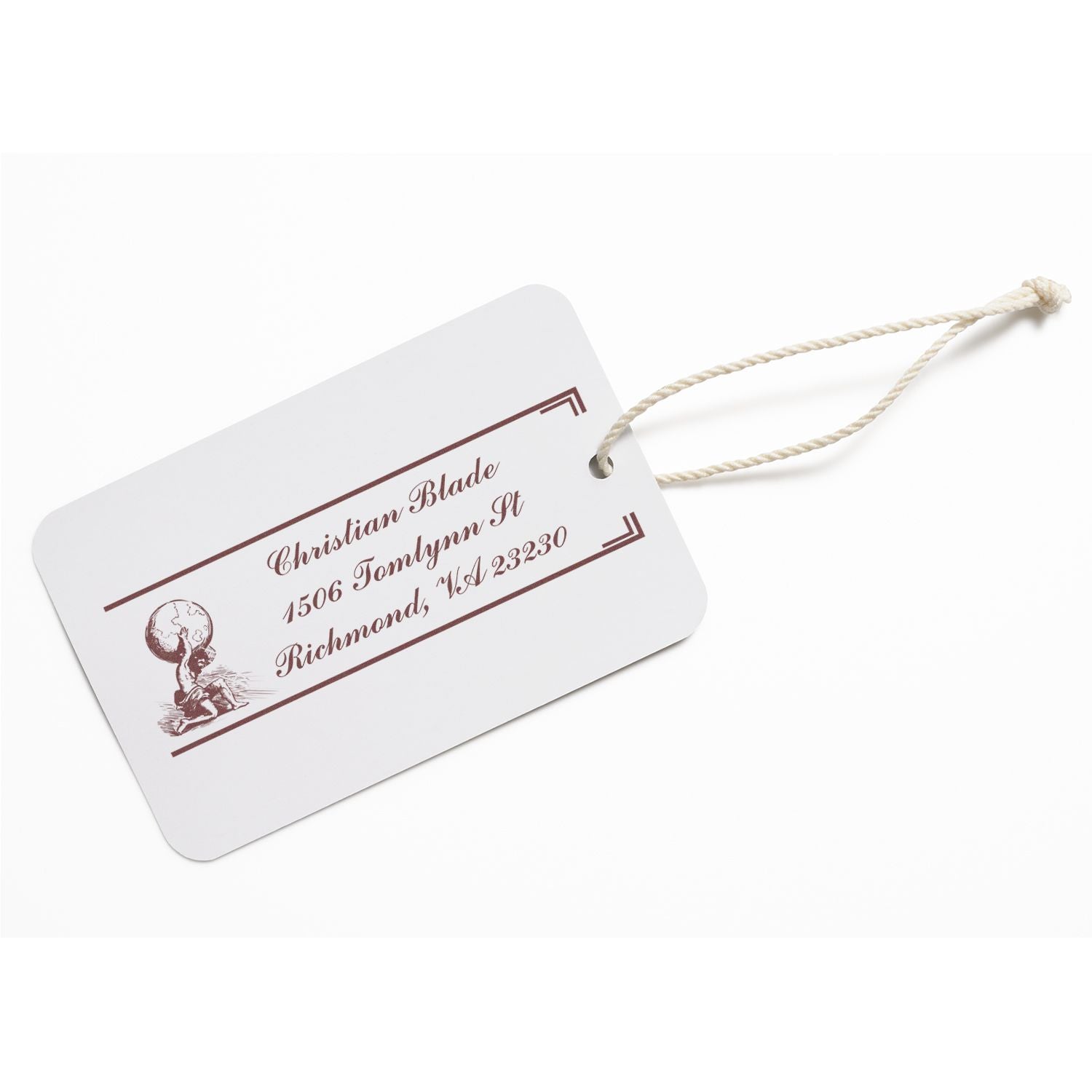Custom address rubber stamp on a luggage tag with name, address, and vintage globe design for personalized stationery.
