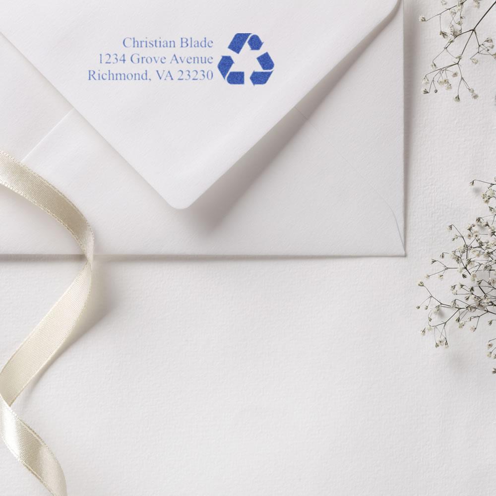 Personalized return address rubber stamp with recycling logo on white envelope