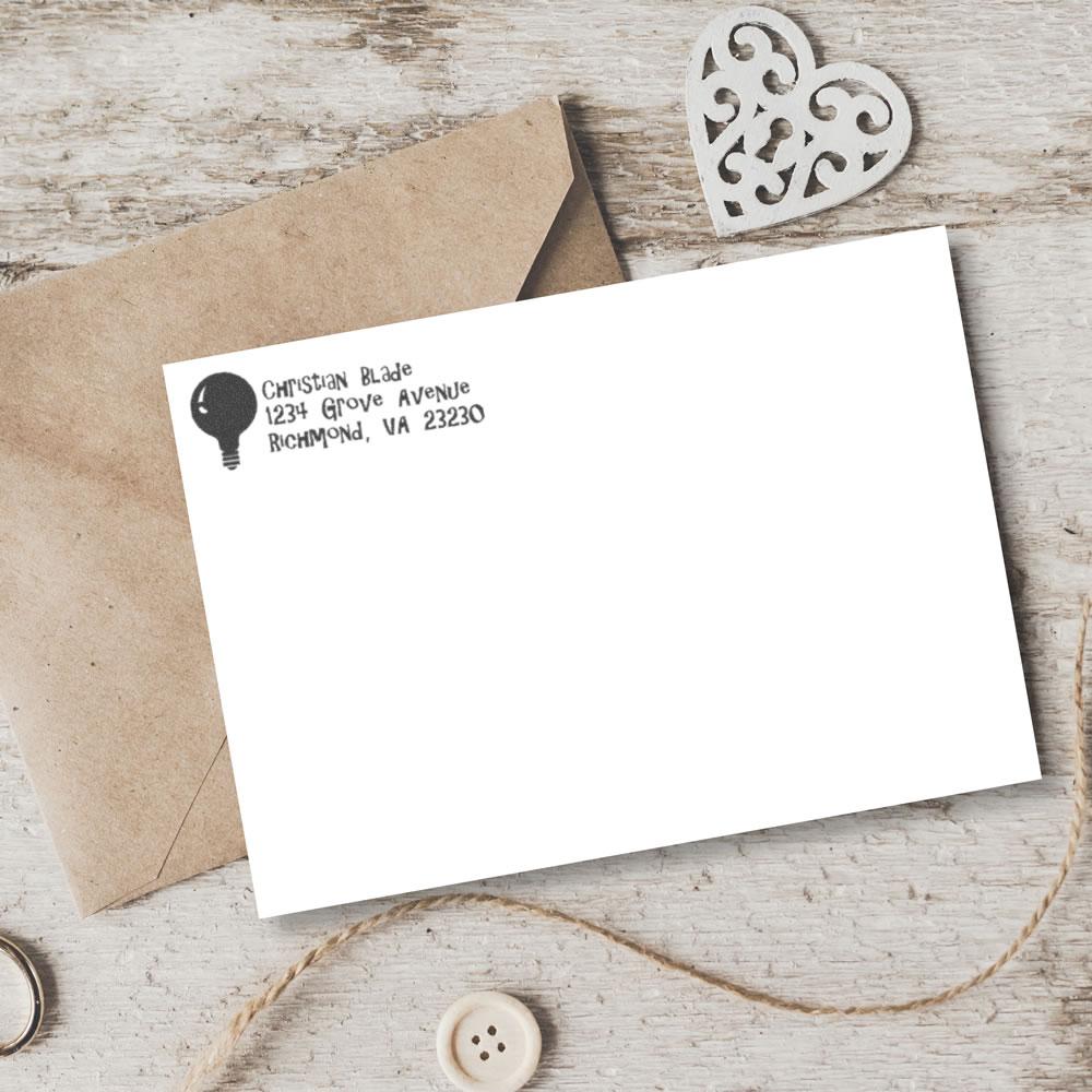 Custom rubber stamp return address on envelope, showing a personalized address stamp for wedding or business stationery.