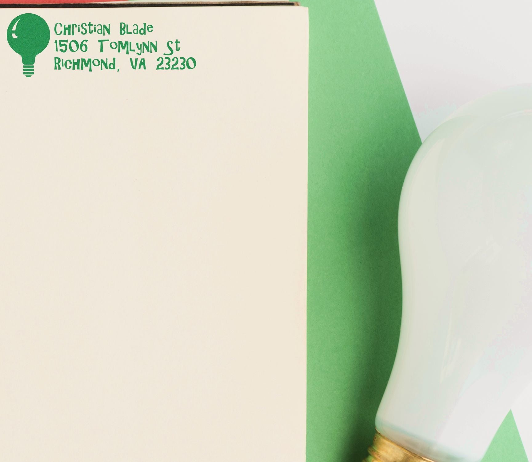 Custom address rubber stamp with light bulb logo, showing Christian Blade Richmond, VA return address on paper.