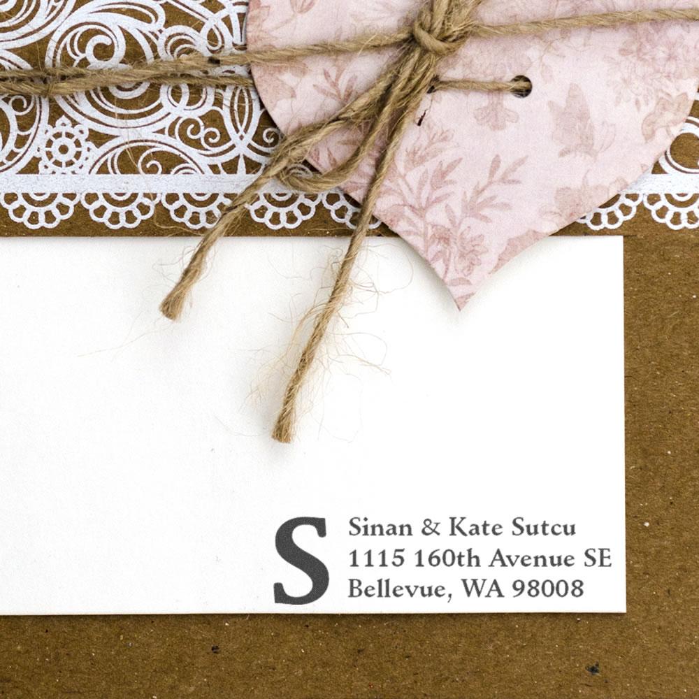 Custom rubber stamp return address on wedding envelope with monogram initial S for personalized stationery.