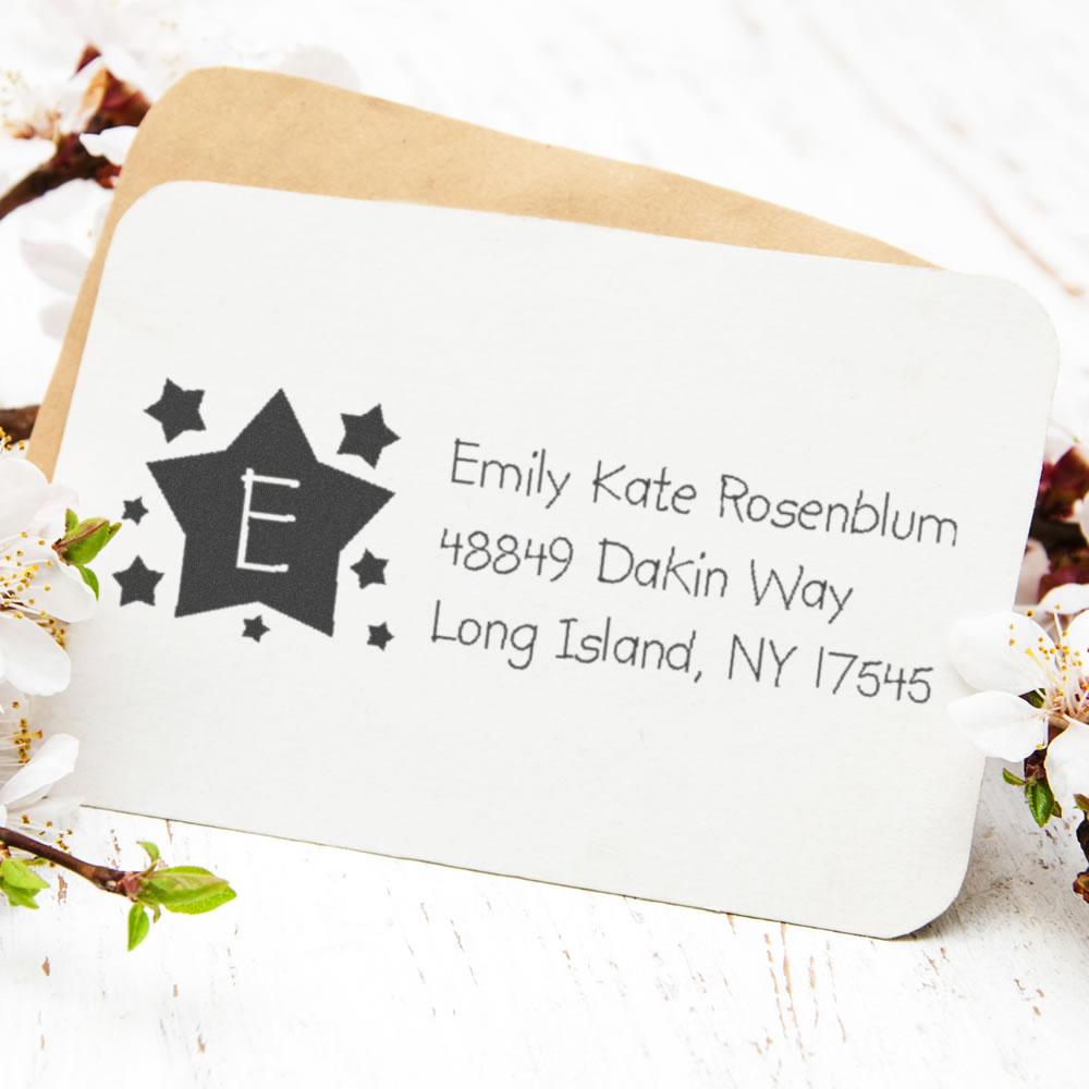 Custom rubber return address stamp with star monogram and Emily Kate Rosenblum address on envelope.