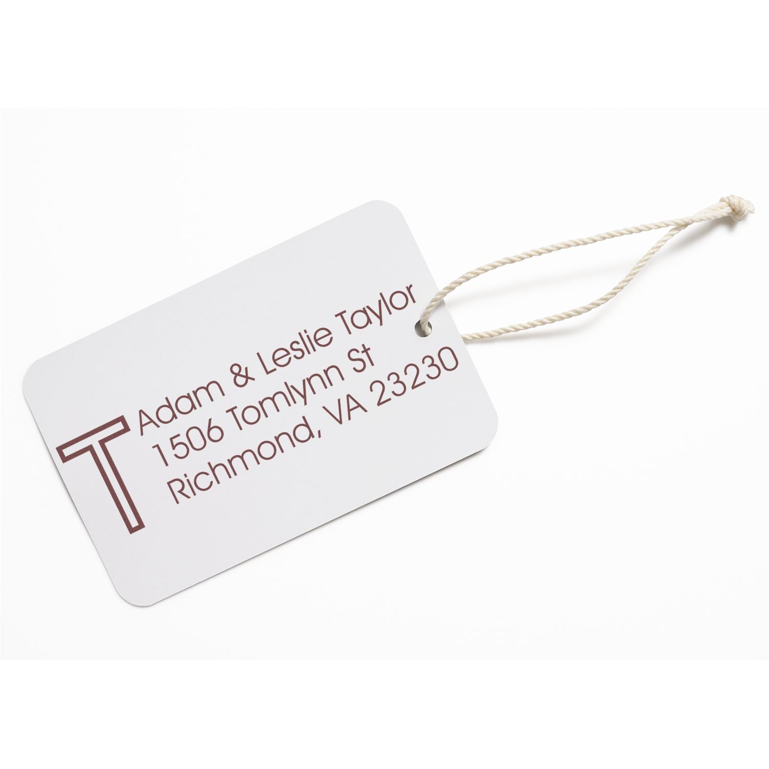 Personalized return address rubber stamp design on a custom hanging tag with monogram, names, and address.