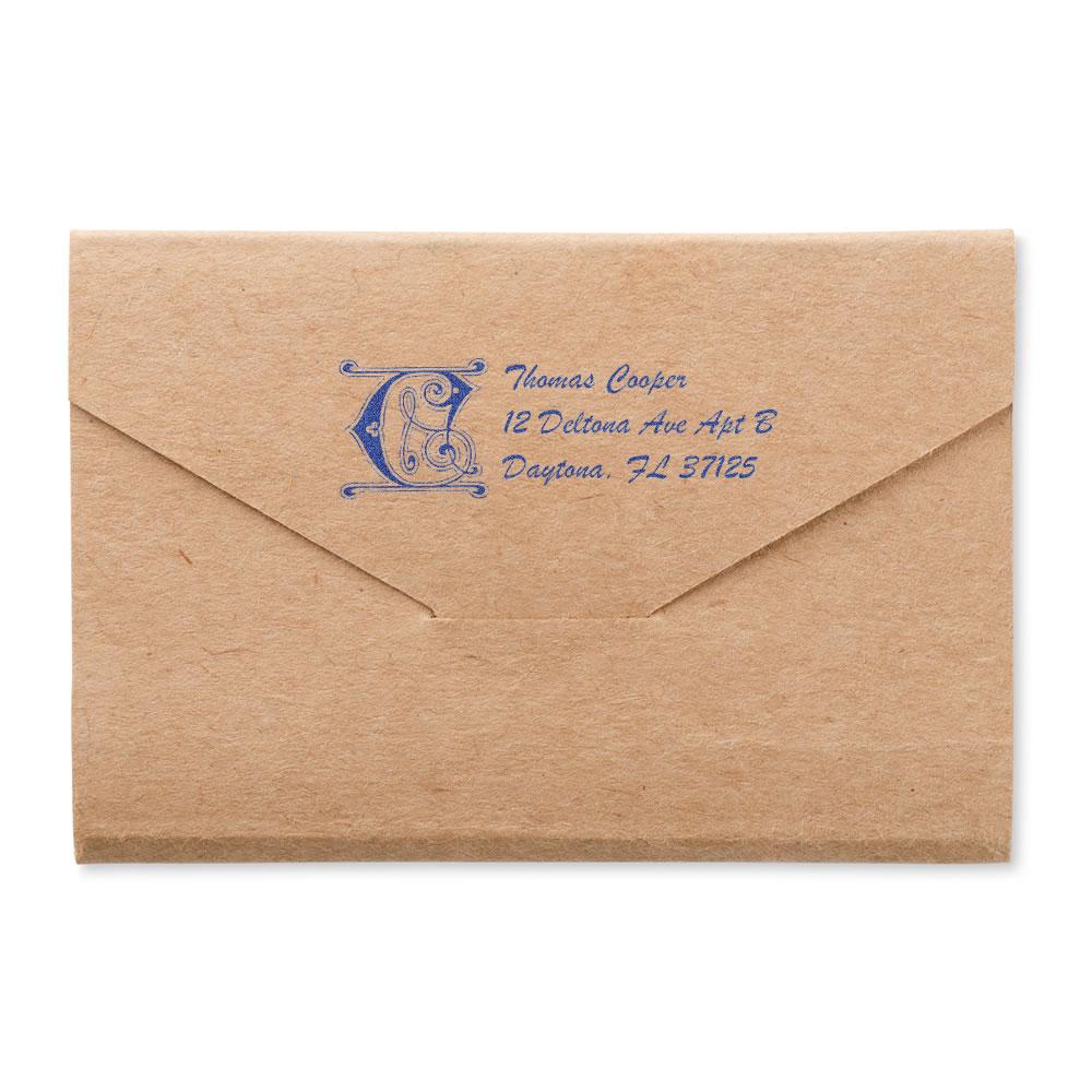 Custom blue return address rubber stamp on a kraft envelope for personalized mailing.
