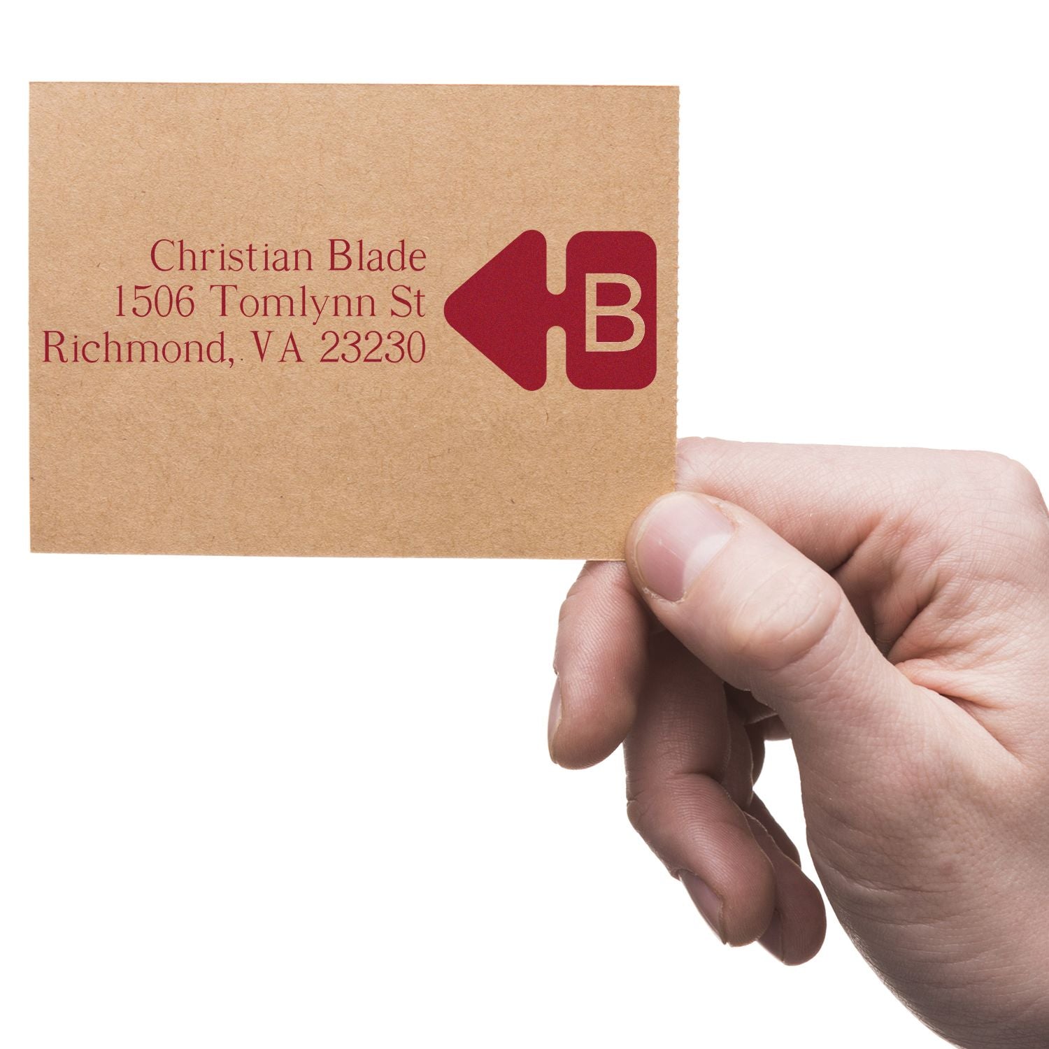 Custom return address rubber stamp on kraft envelope, featuring name, address and logo for business mailing.
