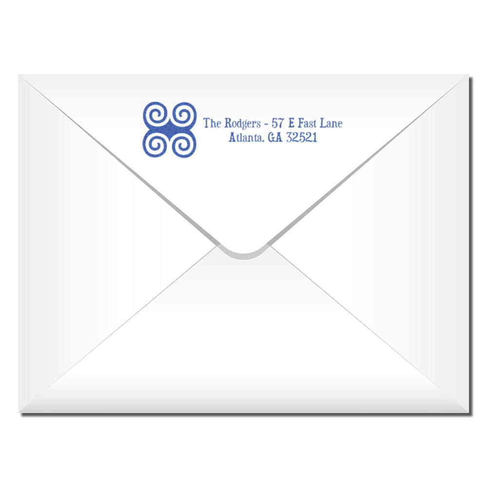 Custom rubber return address stamp on envelope with blue family name, logo, and mailing address.