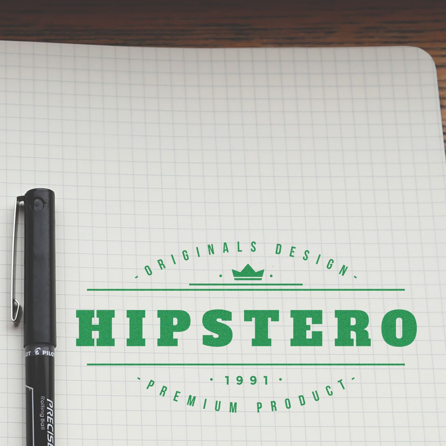 Pen beside notebook showing HIPSTERO Originals Design 1991 Premium Product logo and branding slogan.