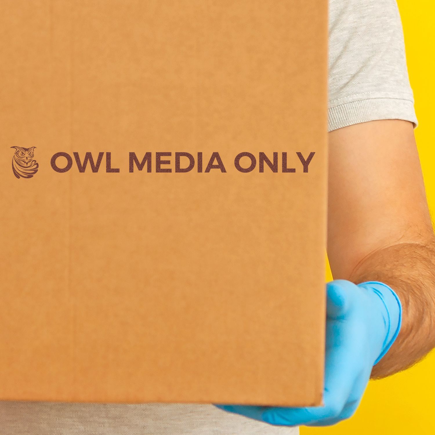 Close-up of OWL MEDIA ONLY logo on orange bag, showing brand-only media message with owl icon for marketing.