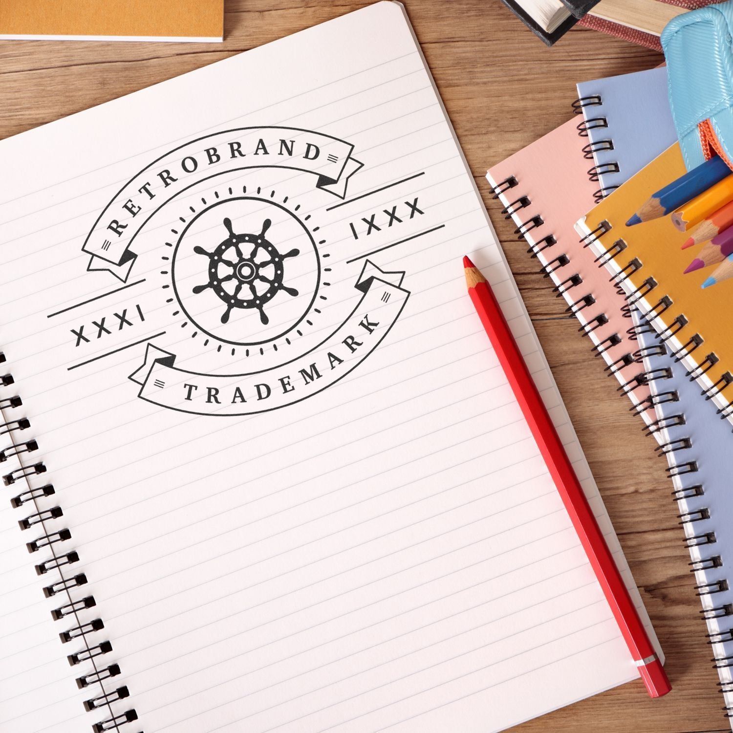 Retro brand trademark logo sketch on a notebook with pencils and stationery on a wooden desk