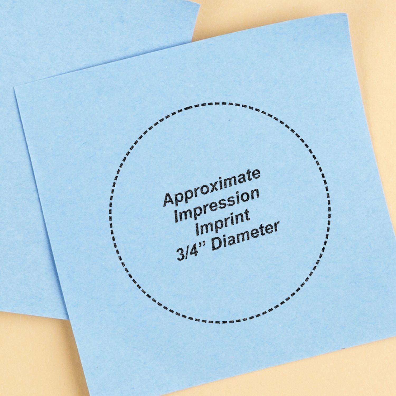 Blue dental impression paper with approximate 3/4-inch diameter imprint circle on a beige background.