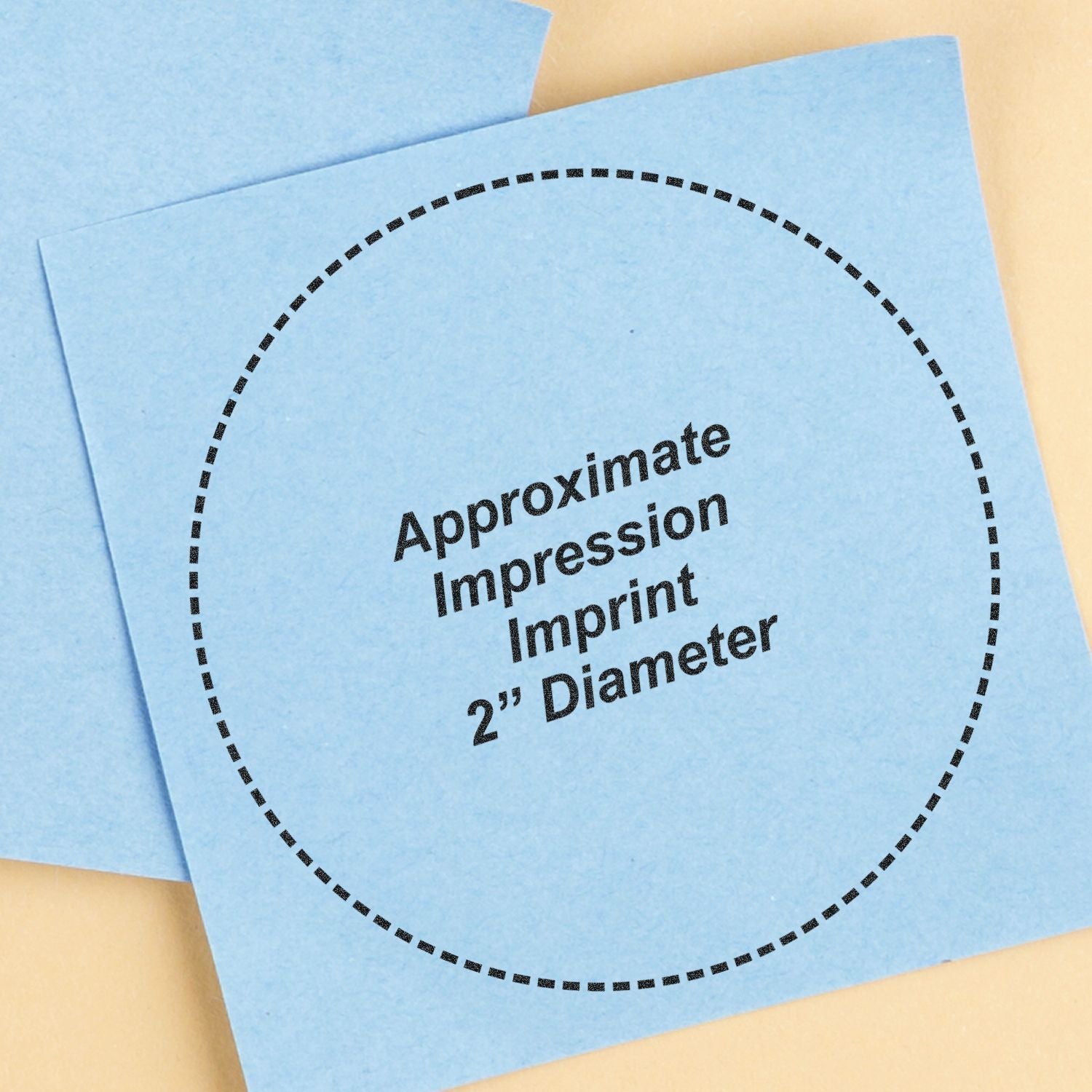 Blue approximate impression imprint 2-inch diameter template on paper with dotted circle outline.