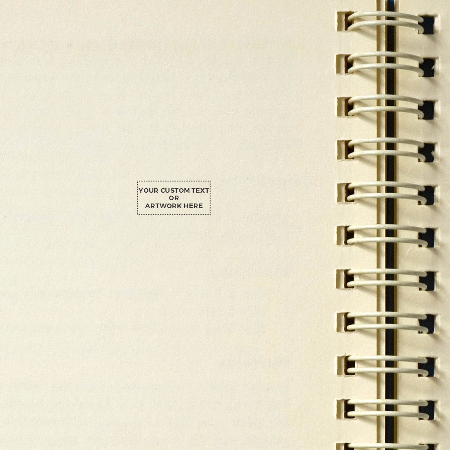 Close-up of a blank spiral notebook cover with customizable text area and metal binding rings, minimalist stationery design.
