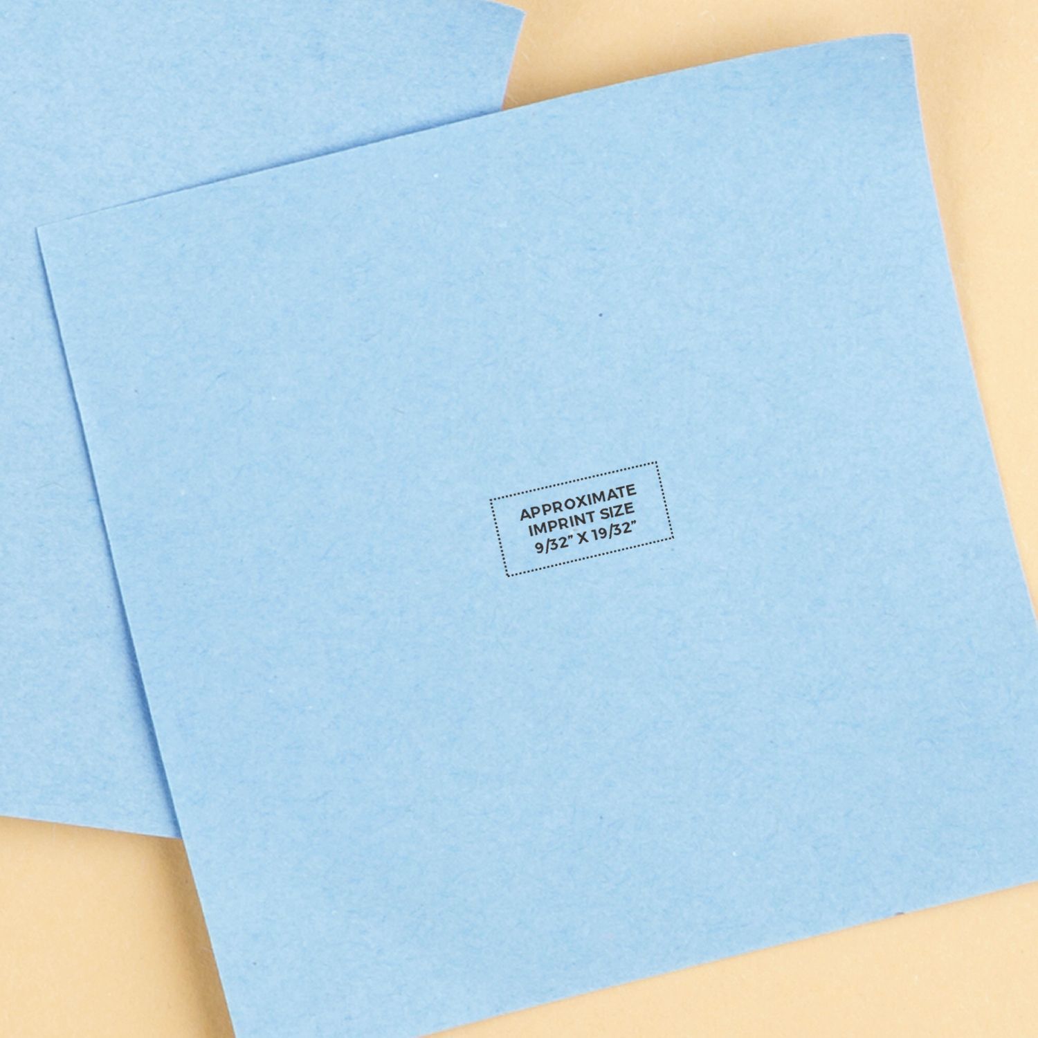 Light blue stationery envelopes with approximate imprint size stamp on beige background, close-up mockup image