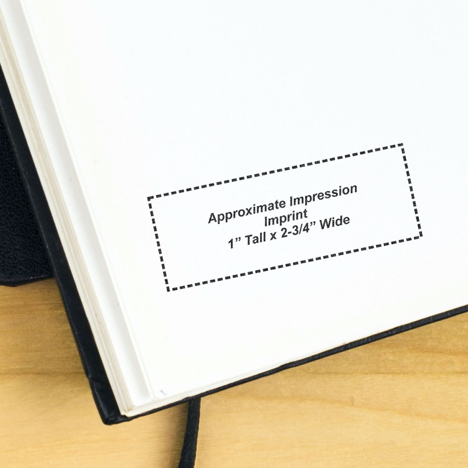 Close-up of open notebook showing approximate impression imprint area, 1 inch tall by 2-3/4 inches wide.