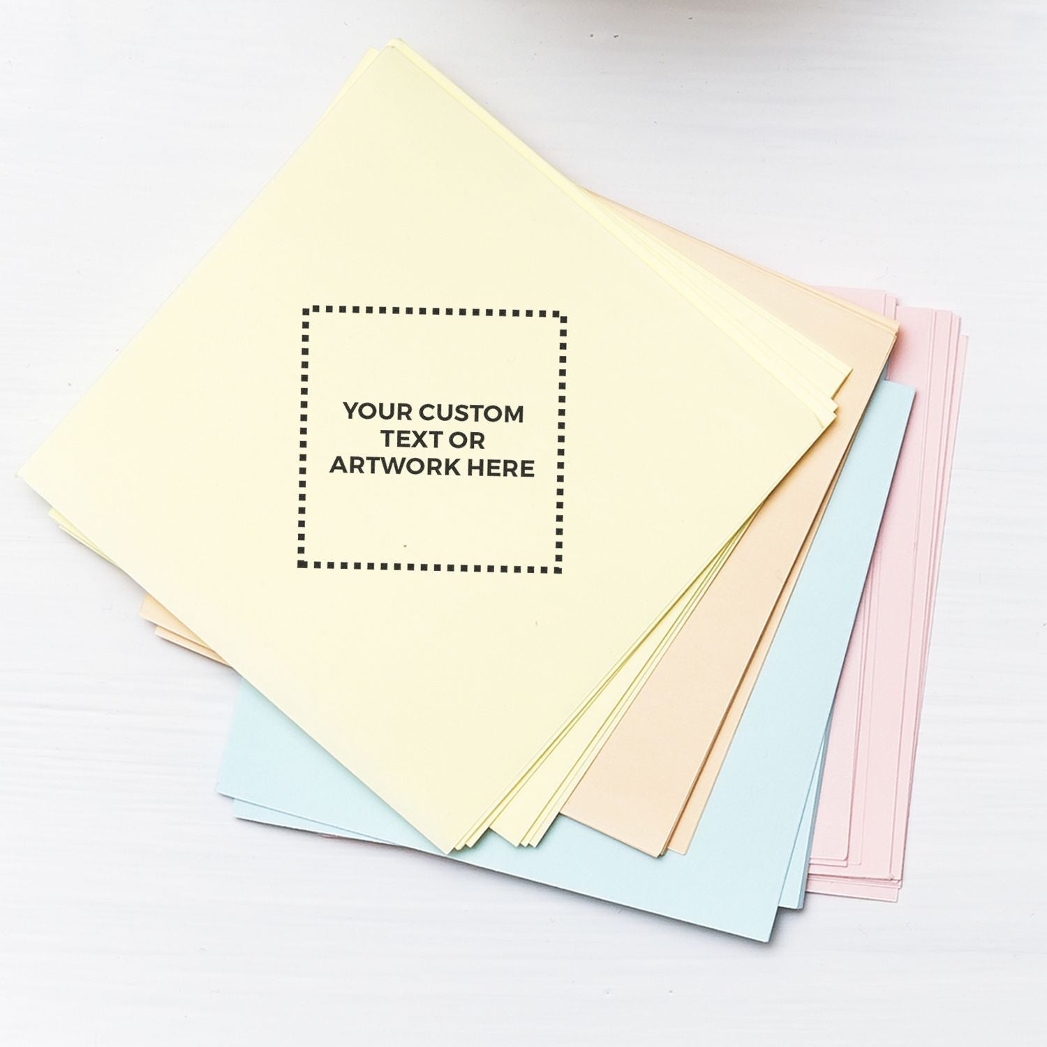 Stack of pastel colored custom printable paper sheets with text placeholder template on white background