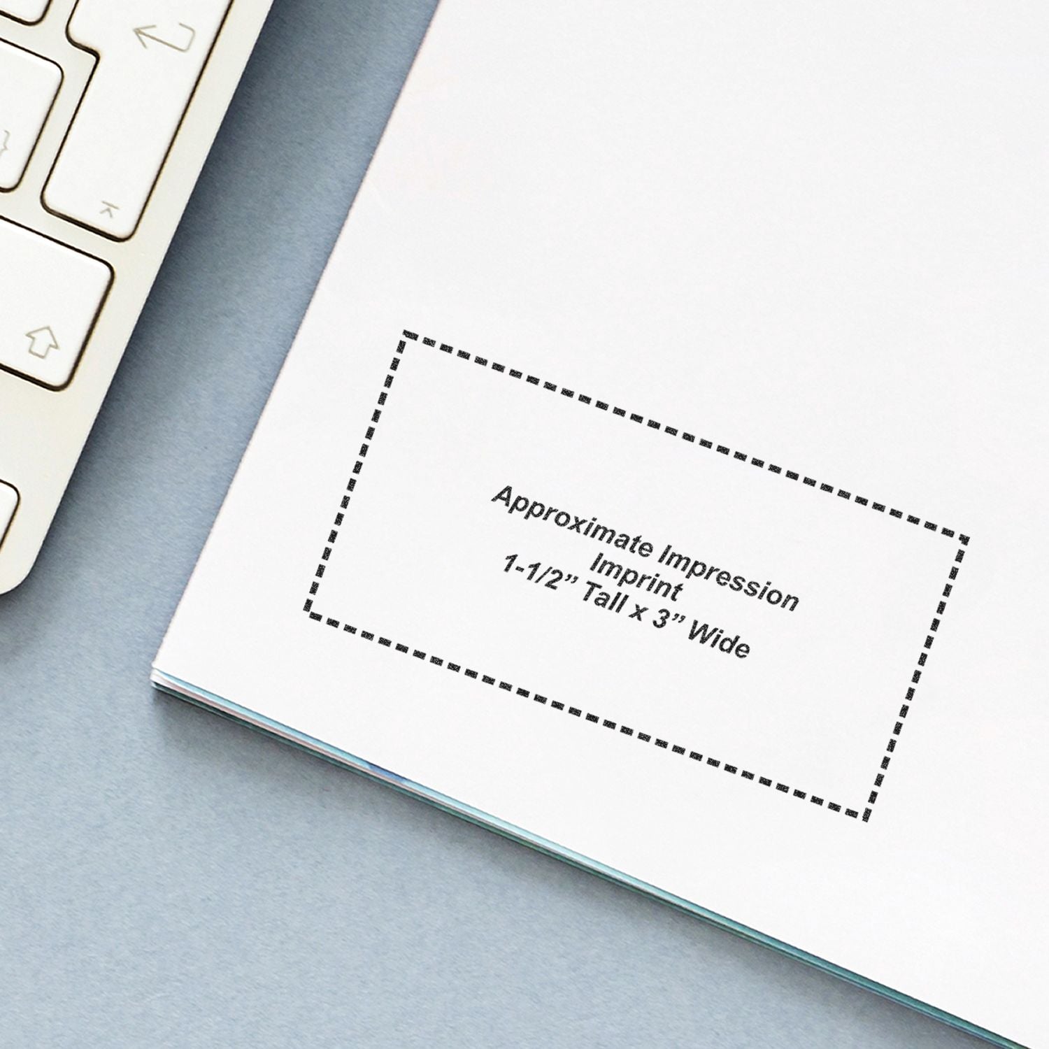 Close-up of a custom notebook page mockup with approximate imprint area and laptop keyboard on a desk.