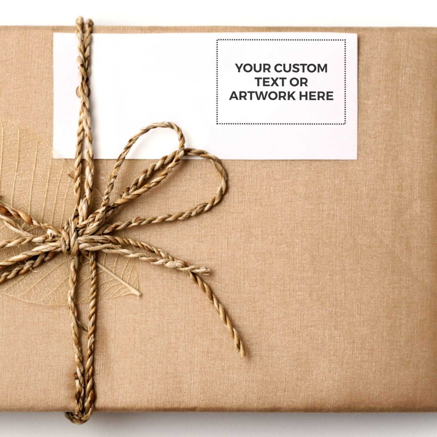 Wrapped eco-friendly gift with twine bow and customizable text tag on brown kraft paper packaging
