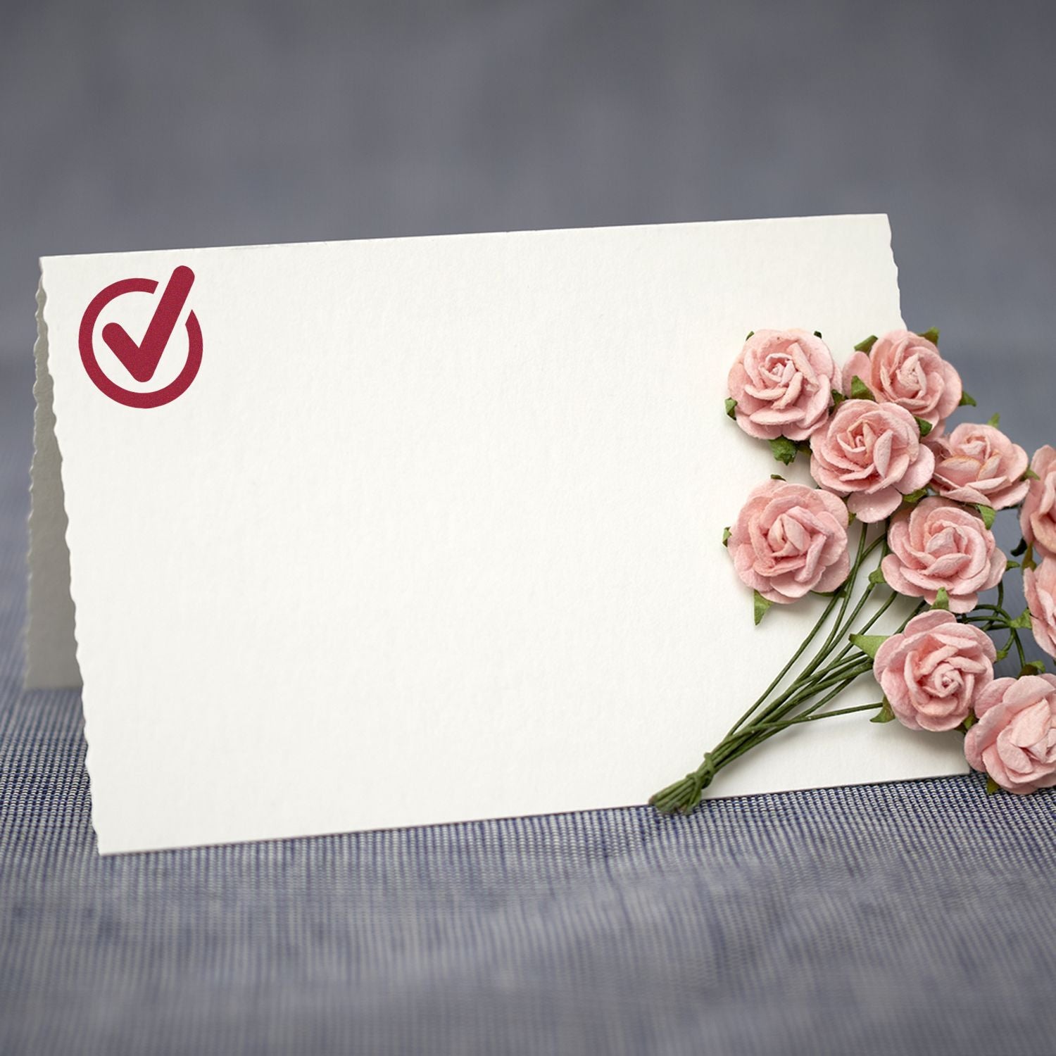 Blank greeting card with red checkmark icon and pink roses, symbolizing confirmation or thank-you message for events