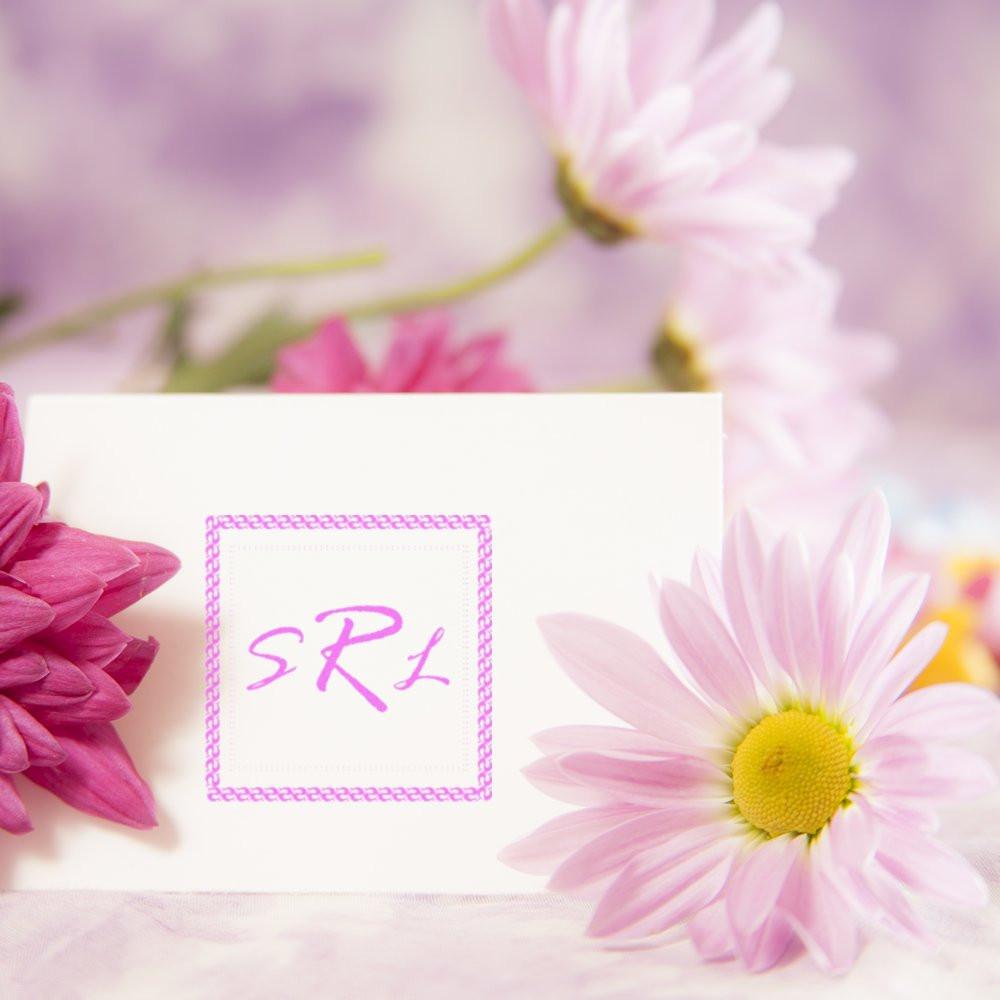 Custom floral rubber stamp monogram SRL on a card, styled with pink daisies for wedding stationery or branding.