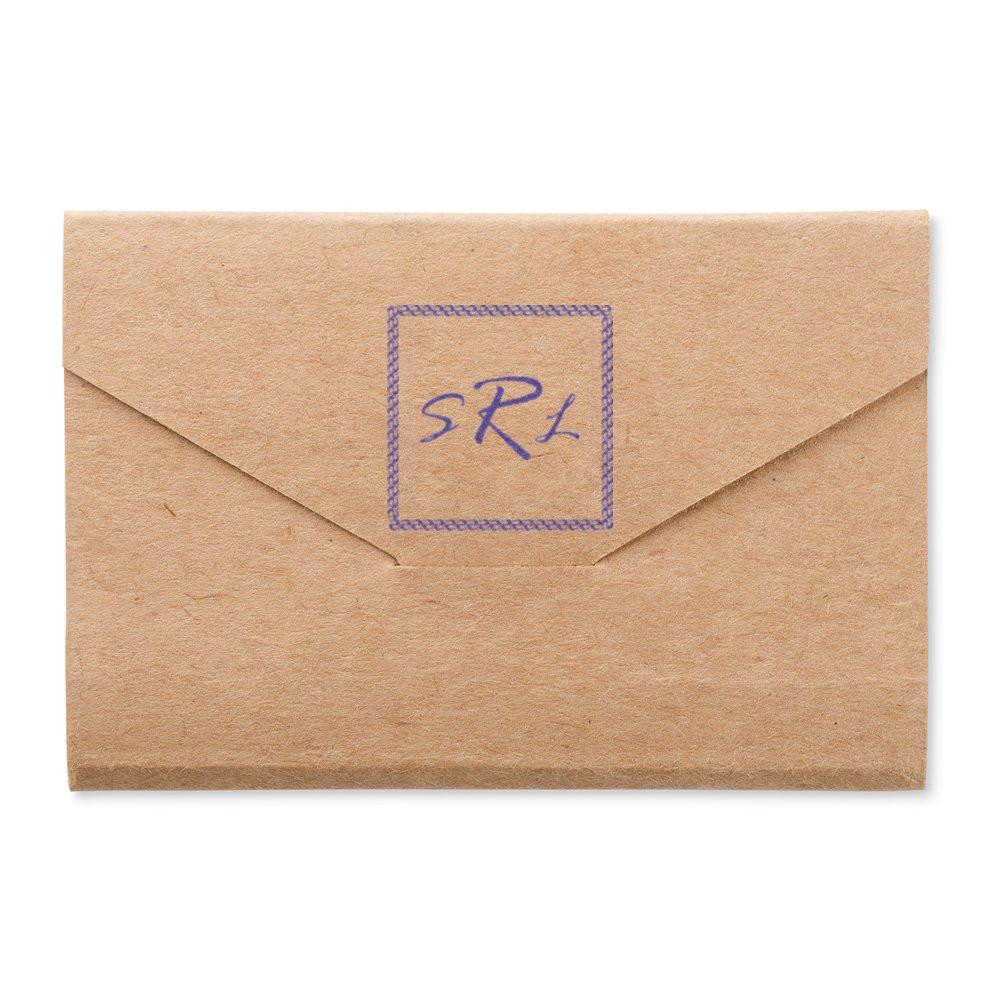 Personalized rubber stamp monogram on kraft envelope for custom stationery and branding.