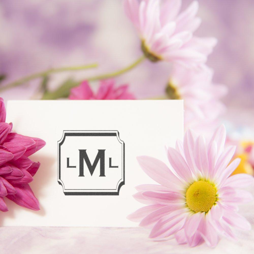 Custom monogram rubber stamp with framed initials, ideal for personalized wedding invitations and stationery.