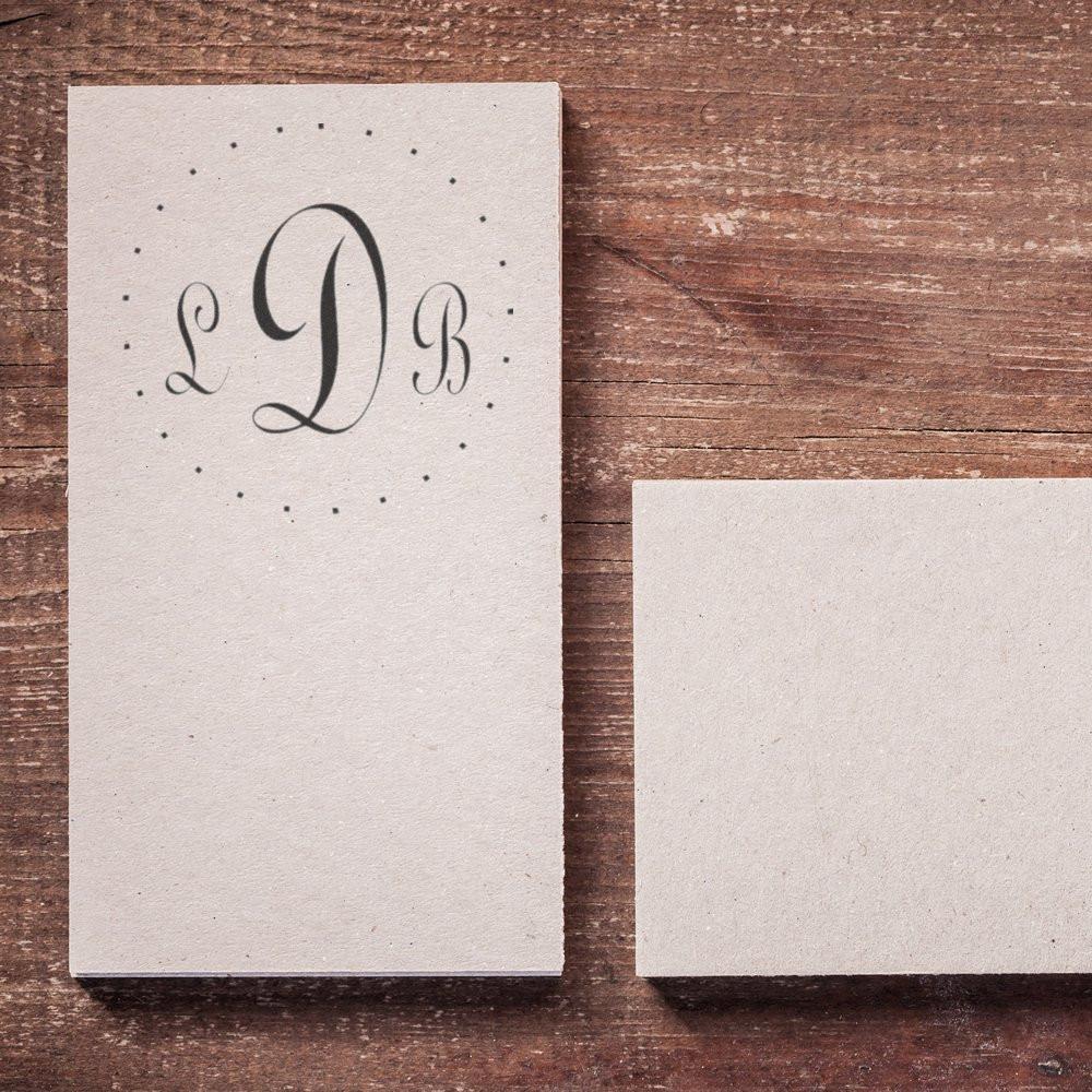 Rustic wooden background with monogram LDB wedding invitation card and blank layout space for text