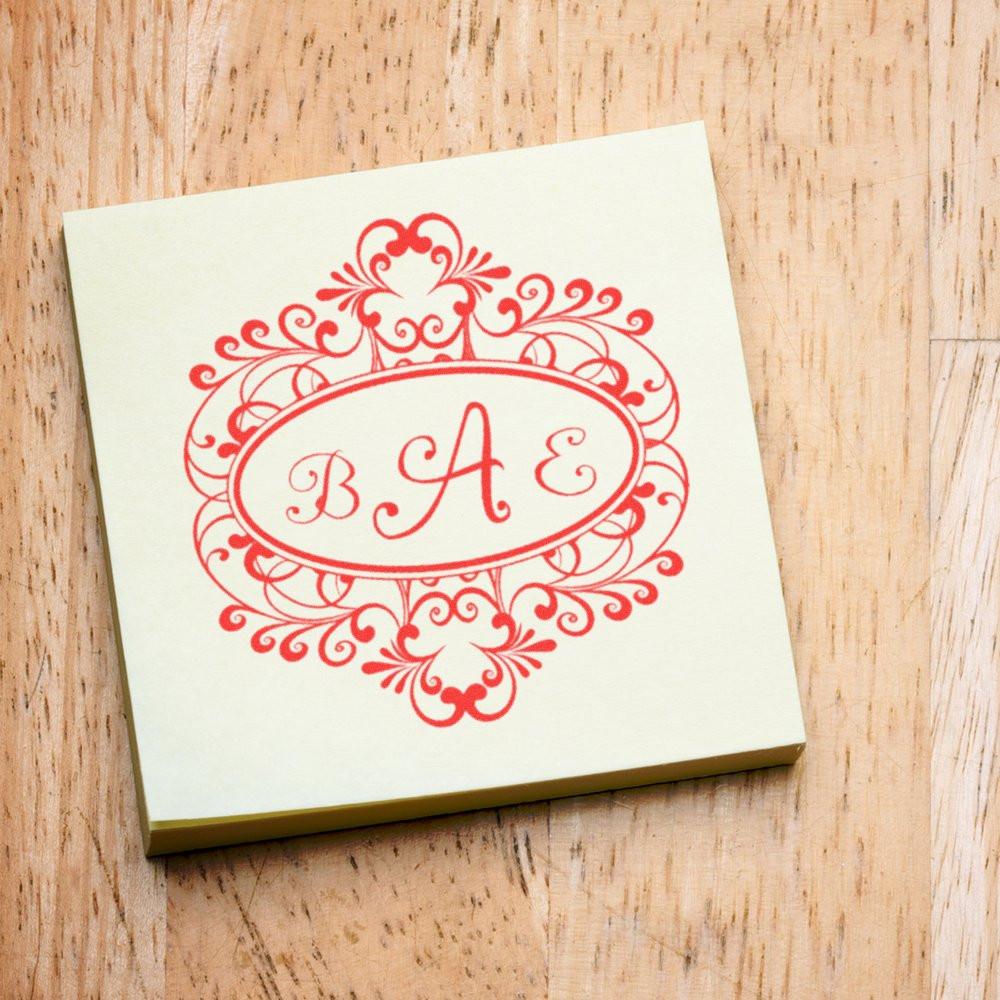 Ornate BAE monogram rubber stamp with floral oval border, ideal for wedding stationery and custom branding.