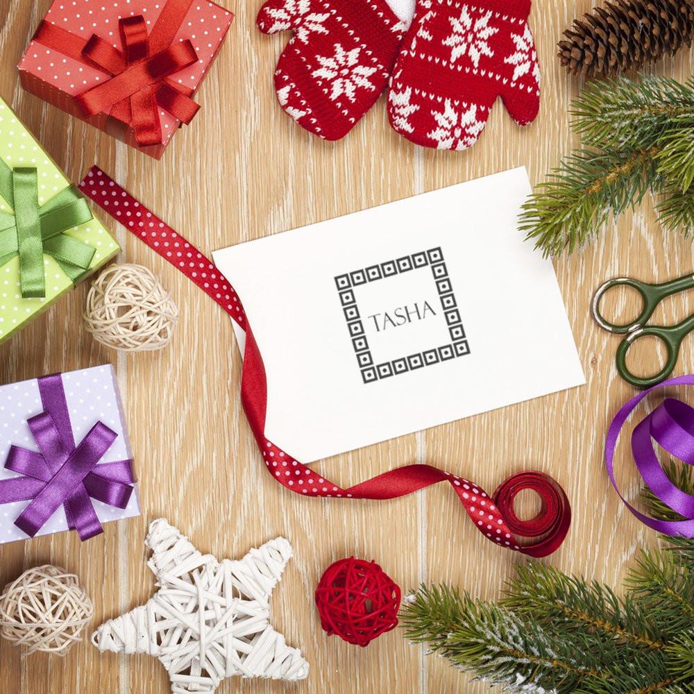 Personalized holiday rubber stamp design on gift wrap for custom name stamping and festive DIY gift tags.