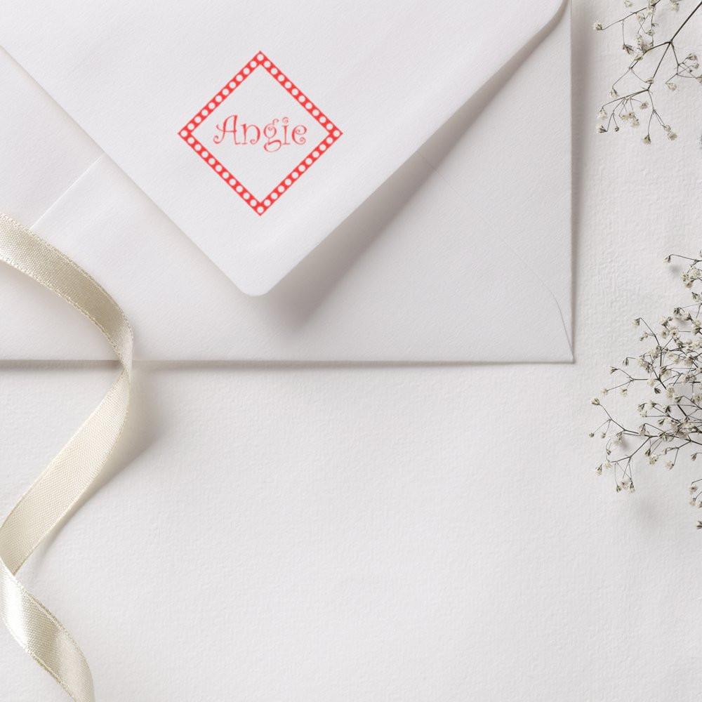 Personalized rubber stamp with name Angie on wedding envelope, ideal for custom stationery and wedding invitations.