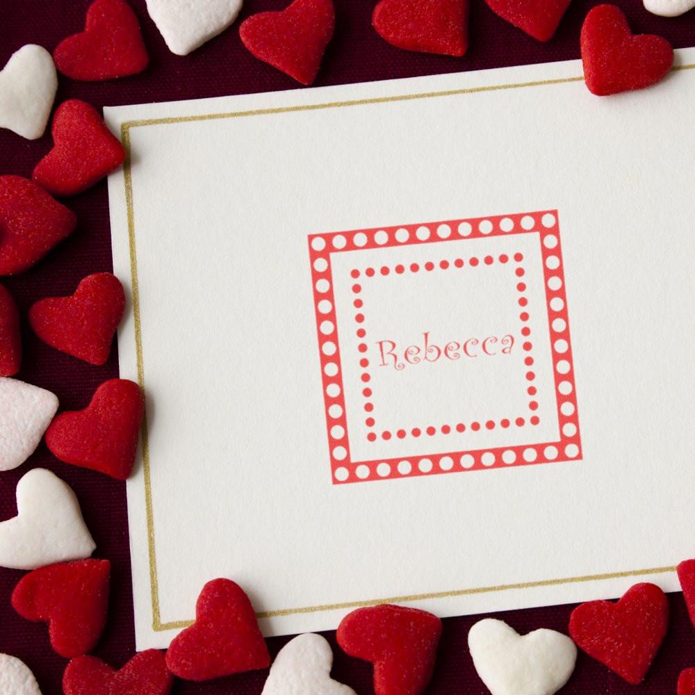 Custom Valentine rubber stamp with name Rebecca on stationery, surrounded by heart confetti for personalized cards and crafts.