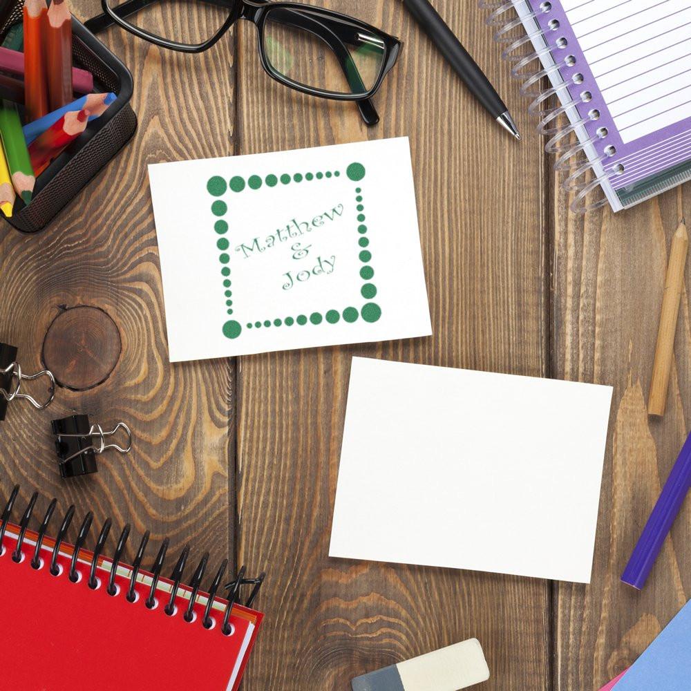 Custom rubber stamp sample for wedding stationery, featuring a green dotted border and Matthew & Jody on a desk.