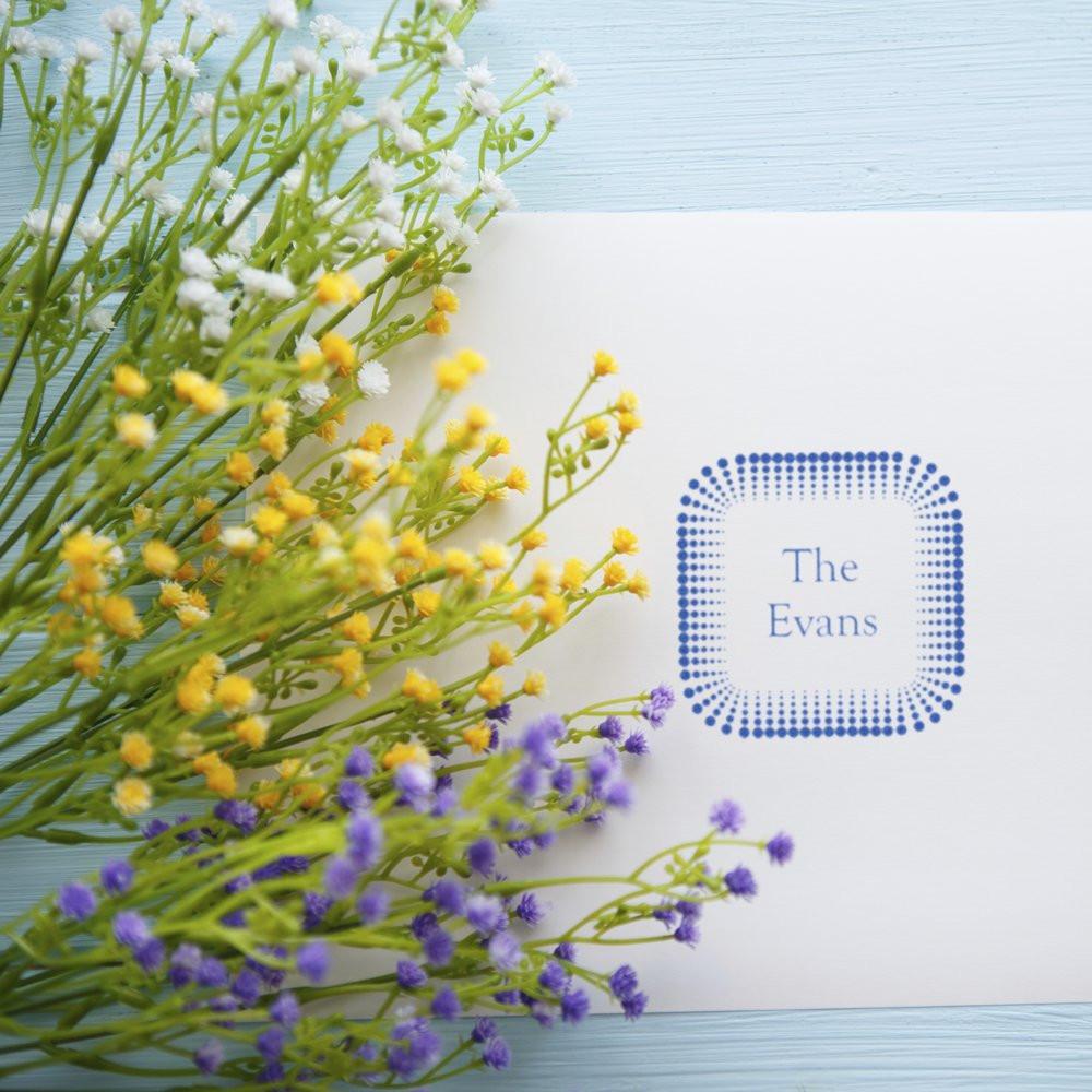 Custom family name rubber stamp with floral border, featuring The Evans for personalized stationery and packaging.
