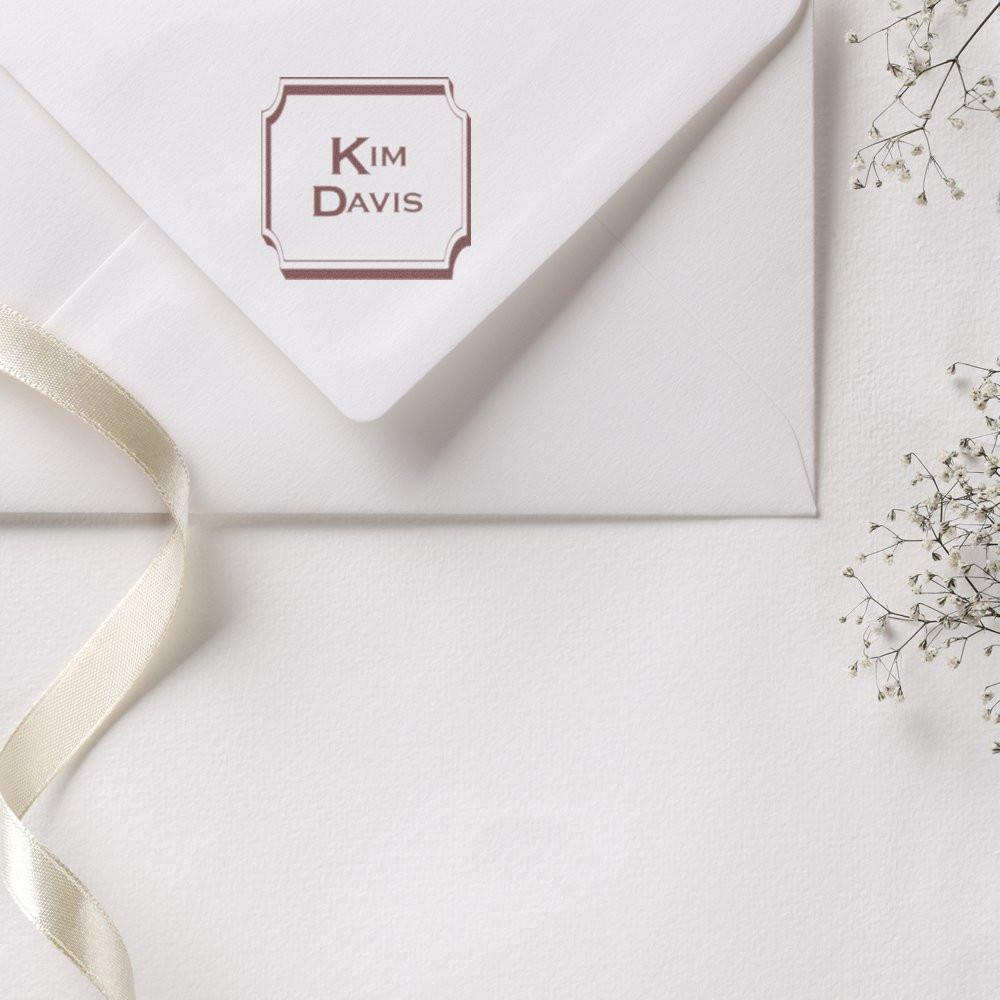 Custom rubber stamp with name on elegant wedding envelope for personalized stationery and invitations.