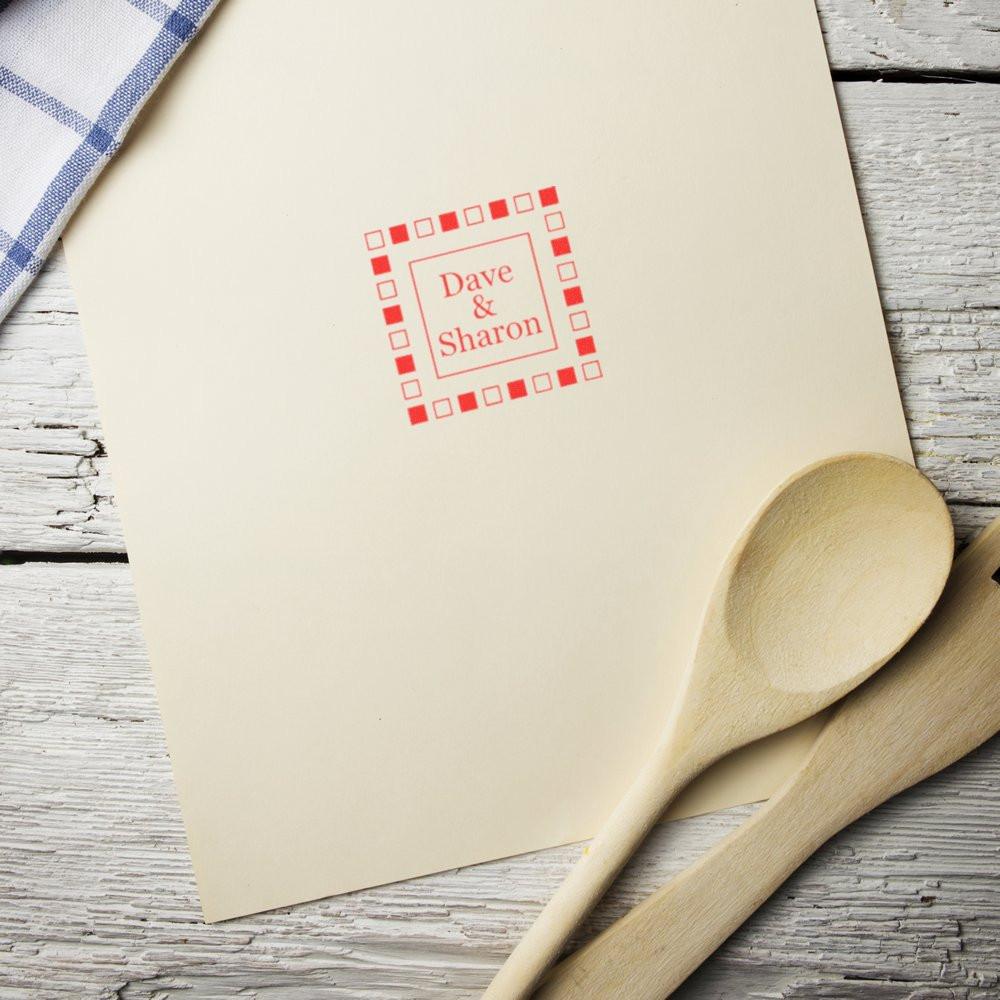 Custom rubber stamp impression with Dave & Sharon on stationery envelope, ideal for personalized wedding invitations