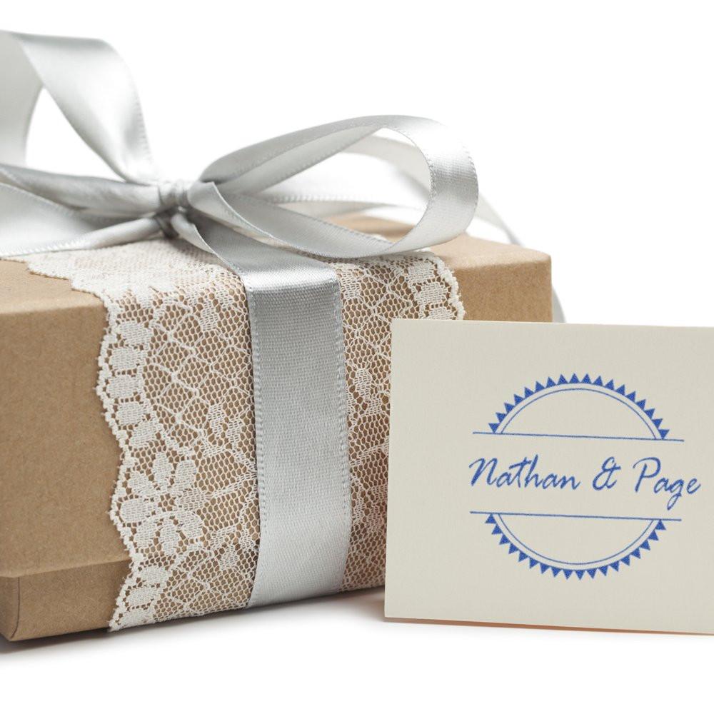 Custom rubber stamp logo on a wrapped gift box, perfect for personalized wedding packaging and gift branding.
