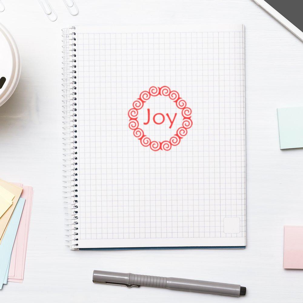 Red Joy rubber stamp on a grid notebook, perfect for handmade cards, planners, and festive craft projects.