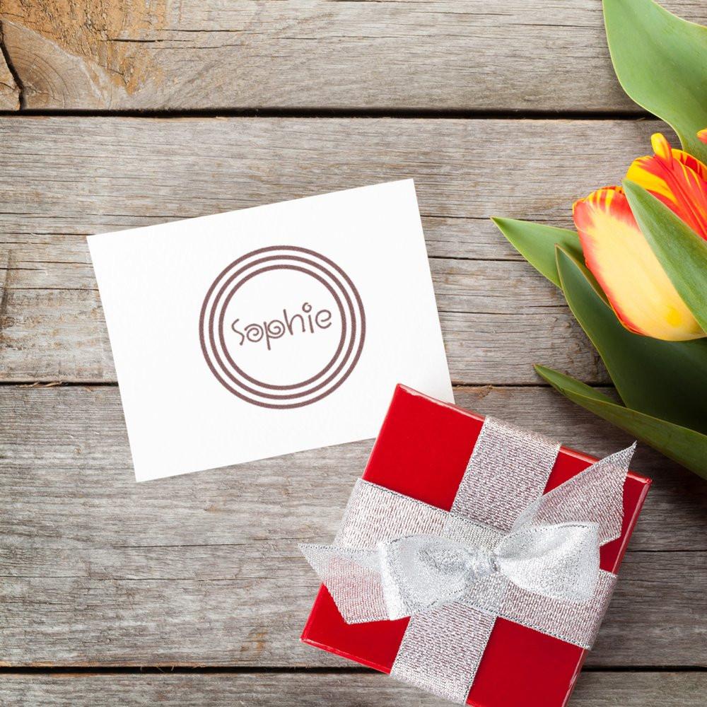Personalized rubber stamp with Sophie logo on a gift card, ideal for custom wedding favors and branded packaging.