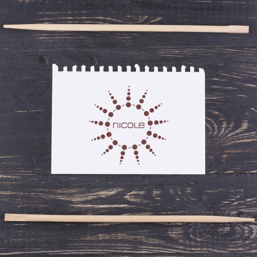 Personalized rubber stamp impression with Nicole name and dotted sunburst logo in a stamp mockup.