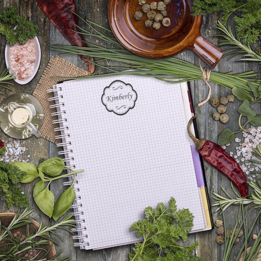 Personalized rubber stamp on notebook with herbs and spices, ideal for custom stationery, branding, and kitchen label designs.