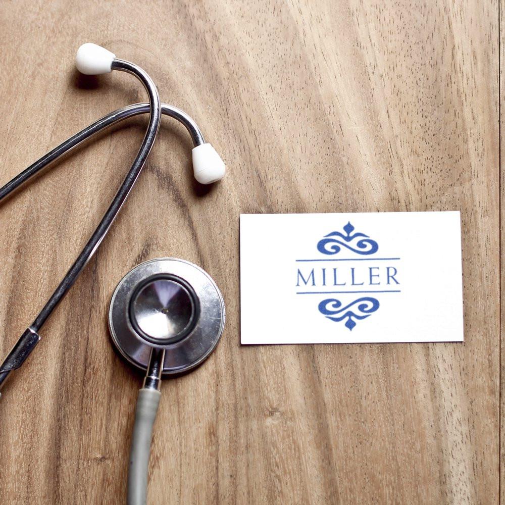 Stethoscope and Miller medical logo card on wooden backgroundhealthcare branding for doctor services and medical consultation clinic