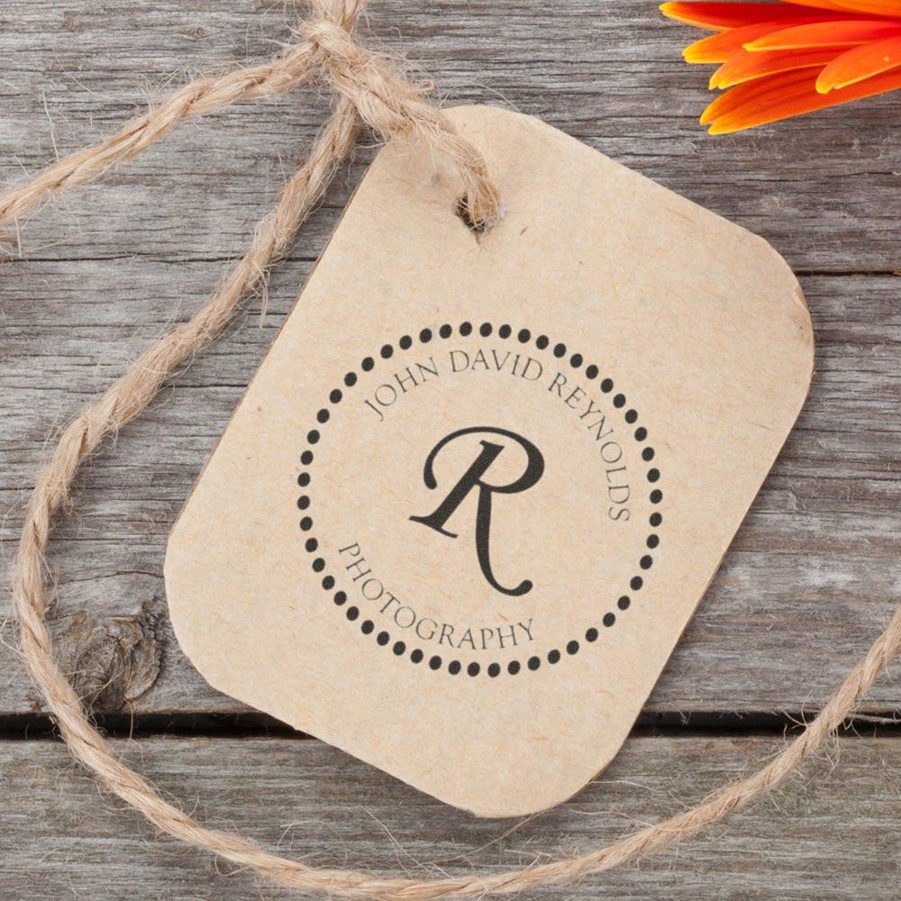 Custom monogram rubber stamp branding on kraft paper gift tag for John David Reynolds Photography