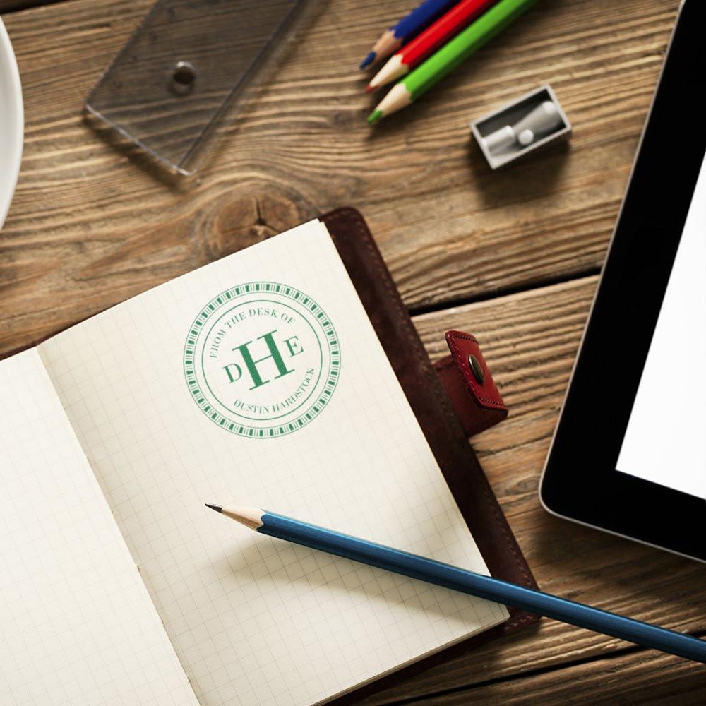 Personalized rubber stamp on notebook for custom stationery, desk branding, and monogram impressions.